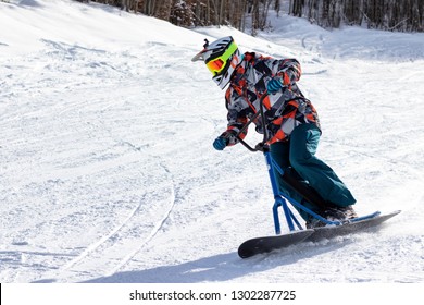 Riding Downhill On A Snow Bike (skiing)