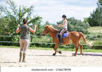  riding girl are training her horse in equestrian center - Powered by Shutterstock