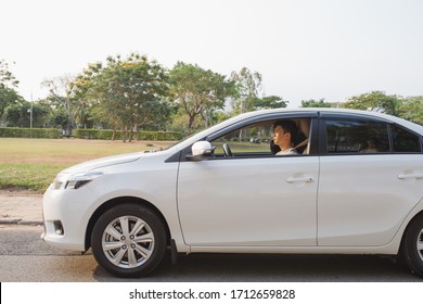 Riding His New Car. Side View Of Handsome Young Man Driving His Car And Smiling