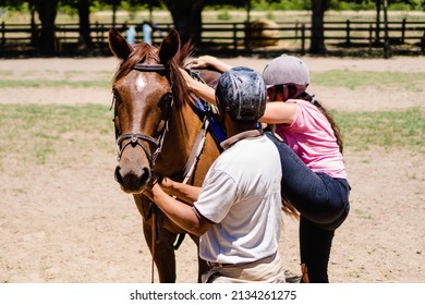 riding instructor, teaching a young woman how to get on the horse - Powered by Shutterstock