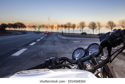 Riding Motorcycle Near Coast In Sunset 