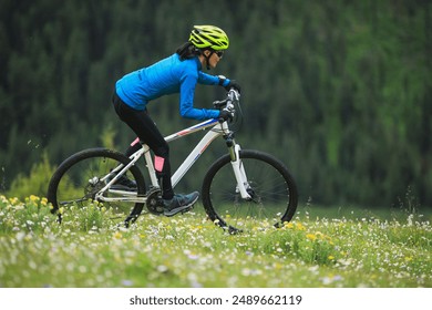 Riding mountain bike on beautiful forest mountain top - Powered by Shutterstock