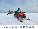 Riding on a snowmobile in Finland, female rider above the Arctic Circle