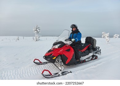 Riding on a snowmobile in Finland, female rider above the Arctic Circle - Shutterstock ID 2207252667
