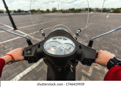 Riding Scooter. Unrecognizable Guy Driving Motorbike Outdoors, Hands On Motorcycle Wheel. POV, Selective Focus