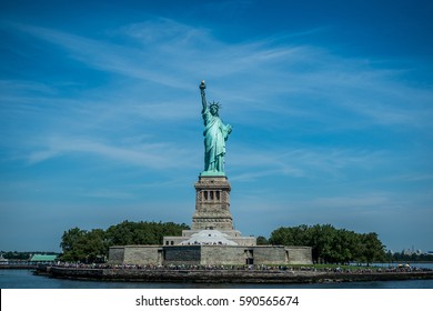 Riding tour boat from Manhattan Island, New York city around the Statue of liberty that is a gift from the France to the people of the United States in the beautiful summer day with blue sky.