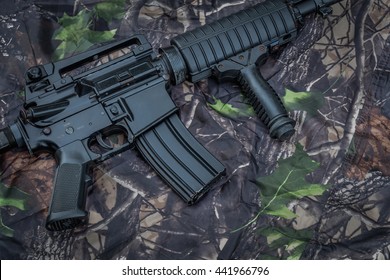 Rifle BB gun on camouflage background.
