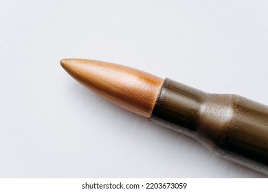 Rifle Bullet Long Cartridge On White Background. Army Or Hunting Weapon Shot Object, Violence And Danger Symbol.