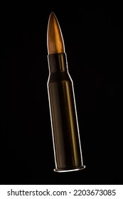 Rifle Bullet Long Cartridge On Black Background. Army Or Hunting Weapon Shot Object, Violence And Danger Symbol.