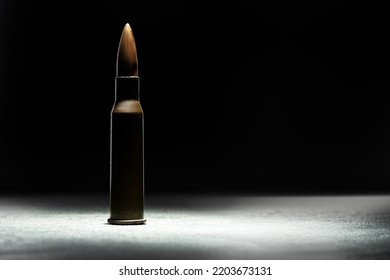 Rifle Bullet Long Cartridge On Black Background. Army Or Hunting Weapon Shot Object, Violence And Danger Symbol.