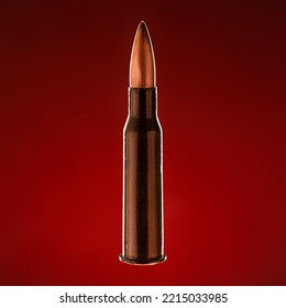 Rifle Bullet Long Cartridge On Red Background. Army Or Hunting Weapon Shot Object, Violence And Danger Symbol.