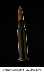 Rifle Bullet Long Cartridge On Black Background. Army Or Hunting Weapon Shot Object, Violence And Danger Symbol.