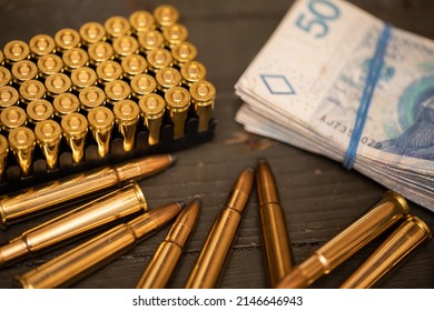 Rifle And Pistol Cartridges Lie Along With Paper Bills.