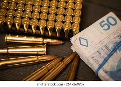 Rifle And Pistol Cartridges Lie Along With Paper Bills.