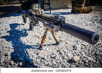 Rifle With Suppressor, Red Dot Sight, Bipod And Light