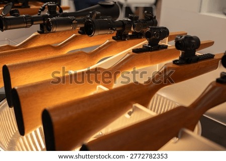 Rifles With Different Scopes And Red Dot Sights.