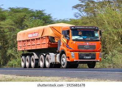 Rift Valley Province, Kenya - January 31, 2021: Chinese semi-trailer dump truck FAW J5 at the interurban road.