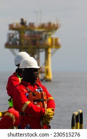 Rig Workers And An Oil Platform