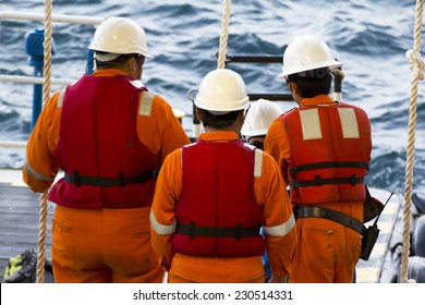 Rig Workers Using A Swing Rope Prior Of Being Transported To Nearby Rigs By Boat 