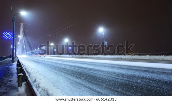 Riga bridge (Vansu tilts) at a snowy winter\
night with Christmas\
illumination