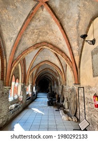 RIGA, LATVIA - 09.03.2020. Cloister of Riga Cathedral. Shabby brick walls and repeating arches of the roof beams of a cloister in Dome. Ancient artifacts inside of the inner courtyard Gallery