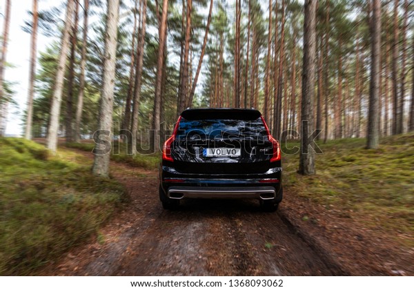 Riga,\
Latvia 12 April 2019 The Volvo XC90 is a mid-size luxury crossover\
SUV driving in forest motion blur with Volvo\
plate