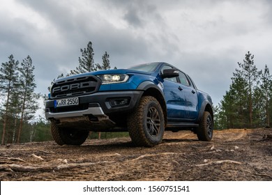 Riga, Latvia 14 November 2019 Ford Ranger Raptor T6 Mid-size Pickup Truck Stand On Top Of Hill. Background Forest With Forest Fir With Pine Trees And Moss.