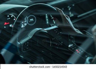 Riga, Latvia 19 February 2020, Woman Is Sitting In Porsche Car, Hands On Steering Wheel, Dashboard With Navigation System.  Speedometer.  