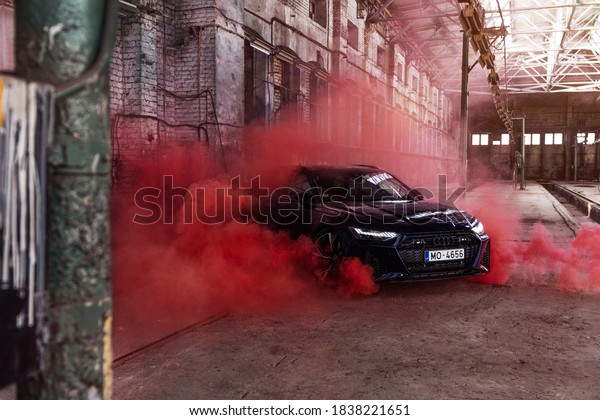 Riga\
Latvia 21 October 2020 Audi RS 6 Avant Fourth generation (C8/5G)\
stands on industrial with led lights on. red\
smoke.