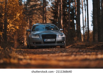 Riga, Latvia 21 October 2021: Front view of Audi A6 3.0 TDI Quattro on a forest road during a sunny autumn day