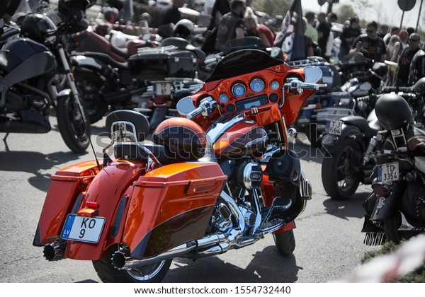 RIga, Latvia 27.04.2019 Motorcycle season open\
day. Orange big chopper. Biker rally. Many bikes lined up in a row.\
  Meter panels and handle bars of various Harley Davidson easy\
rider motorcycle