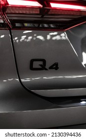 Riga, Latvia 28 February 2022 The Audi Q4 e-tron Sportback is a battery electric compact luxury crossover SUV produced by Audi. Stands in parking, led light on. Rear view, close up to Q4 logotype