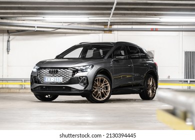 Riga, Latvia 28 February 2022 The Audi Q4 e-tron Sportback is a battery electric compact luxury crossover SUV produced by Audi. Stands in parking, led light on. Front and side view.