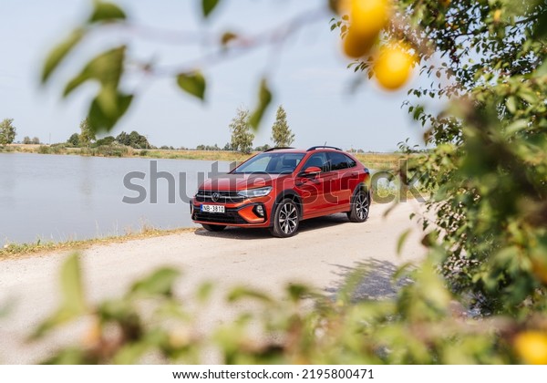 Riga,\
Latvia 30 August 2022 The Volkswagen Taigo is a subcompact\
crossover SUV 2023 Volkswagen Taigo R-Line or Nivus. Stands by lake\
on road, led light on. Front side close up\
view.