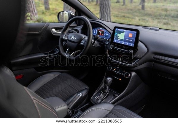 Riga, Latvia 7 October 2022 The Ford Puma ST is a\
subcompact crossover SUV EcoBoost Hybrid mHEV. Stand in pine forest\
and landscape panoramic view at Sunny day. Interior dashboard\
view.