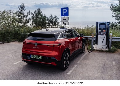 Riga, Latvia 8 July 2022, Renault Megane E-Tech Electric Is A Battery Electric-powered Small Family Car. Charging Station, Charging The Car On Parking Lot. Landscape View To Sea.