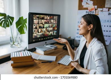 Riga, Latvia - April 04 2020: Beautiful Young Woman Having Zoom Video Conference Call Via Computer. Zoom Call Meeting. Home Office. Stay At Home And Work From Home Concept During Coronavirus Pandemic