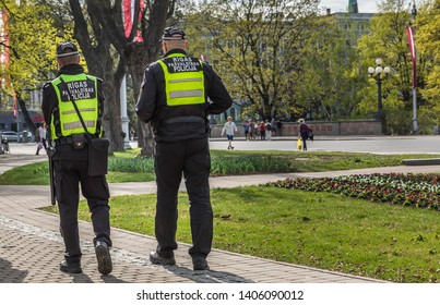 Riga, Latvia, April 2019 - Police Officers Patrolling In The Park.