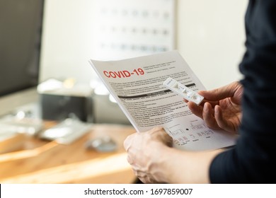 Riga, Latvia - April 8 2020: Coronavirus SARS-CoV-2 Testing At Home. COVID-19 Rapid Test Cassette For Coronavirus. Man Holding A Rapid Testing Kits. Coronavirus Antibody Test