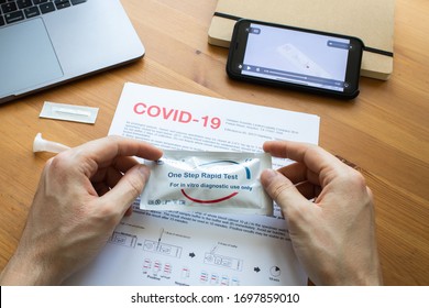 Riga, Latvia - April 8 2020: Coronavirus SARS-CoV-2 Testing At Home. COVID-19 Rapid Test Cassette For Coronavirus. Man Holding A Rapid Testing Kits. Coronavirus Antibody Test