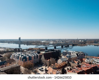 RIGA, LATVIA - April/17/2019: Old town, Rail road bridge over river Daugava, Blue sky. - Shutterstock ID 1426625810