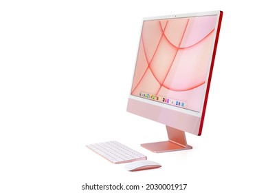 Riga, Latvia - August 22, 2021: Side view of Apple's latest iMac desktop computer with home screen in pink color.
