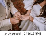 Riga, Latvia, - August 26, 2023 -  Close-up of groom placing a wedding ring on the bride