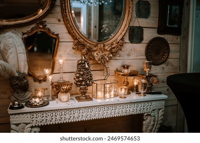 Riga, Latvia, - August 26, 2023 - Ornate vintage decor with golden frames, mirrors, candles, and a carved table against a wooden wall, creating a cozy, elegant ambiance - Powered by Shutterstock