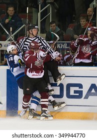 RIGA, LATVIA - DECEMBER 10: Alexander Kitarov (13) and Maris Bicevskis (96) collide with referee in KHL game between Dinamo Riga and Neftekhimik Nizhnekamsk played on DECEMBER 10, 2015 in Arena Riga