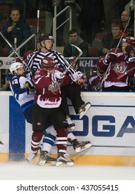 RIGA, LATVIA - DECEMBER 10: Alexander Kitarov (13) and Maris Bicevskis (96) collide into the boards in game between Dinamo Riga and Neftekhimik Nizhnekamsk played on DECEMBER 10, 2015 in Arena Riga