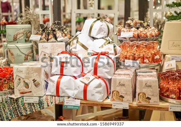 Riga, Latvia - December 11 2019. Riga mall\
Stockman. Christmas fair. Christmas market, Christmas fruit cake.\
Dry fruits. Gifts scattered on the\
table.