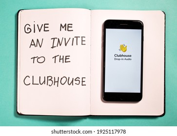 Riga, Latvia - February 24, 2021: Clubhouse drop-in audio application on the smartphone on the turquoise background. New popular social media. Invite to the Clubhouse app