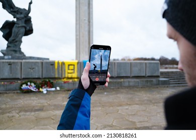 RIGA, LATVIA, FEBRUARY 25. 2022 - The so called "Victory monument" defaced with paint in colors of Ukrainian flag.