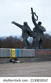 RIGA, LATVIA, FEBRUARY 25. 2022 - The so called "Victory monument" defaced with paint in colors of Ukrainin flag.
